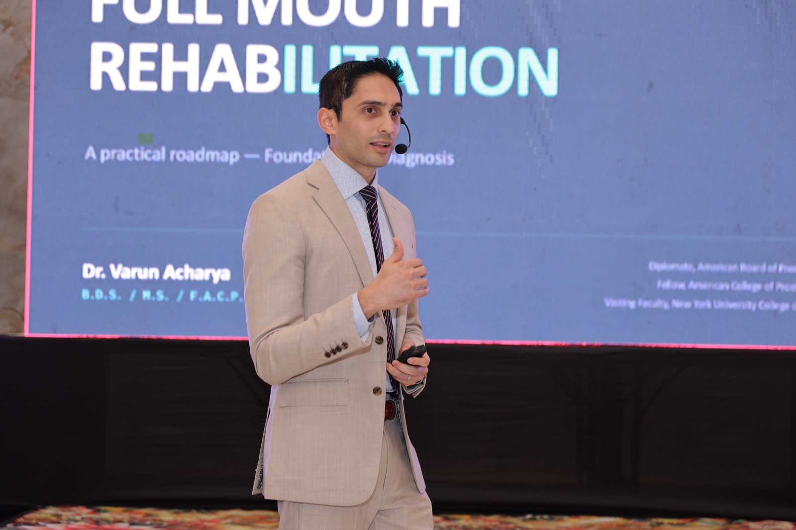 Dr. Acharya lecturing on full mouth rehabilitation at a dental conference